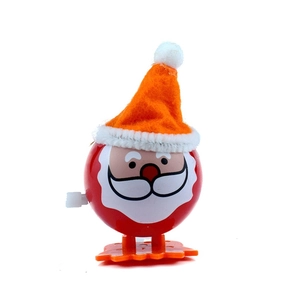 Detail of Santa Claus clockwork toy with red hat and white beard on a white background