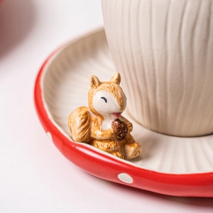 Close-up of ceramic mushroom plate with small 3D squirrel and pinecone detail