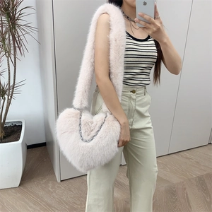 Pink plush heart-shaped crossbody bag with soft faux fur and silver metal chain strap detail