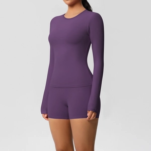 Detail of purple long sleeve yoga top and high waist shorts with seamless matte finish