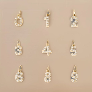 Macro shot of gold-plated number pendants with sparkling pavé crystal embellishments
