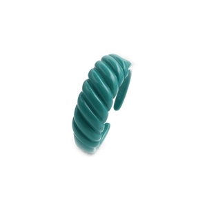 Detail of teal green twisted spiral ring with a high-gloss enamel finish and open band