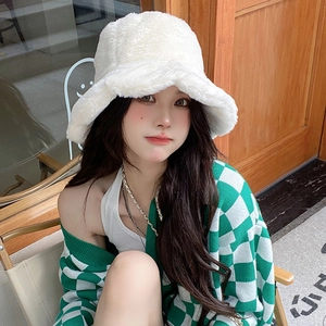 Close-up of white plush bucket hat showing the soft faux fur texture and trendy wide brim