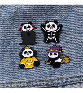 Close-up of four Halloween panda enamel pins on blue denim fabric background