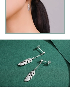 Detailed view of silver hollow leaf tassels showing ear wear and long chain textures