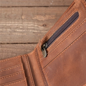 Detail of brown leather wallet interior showing multiple card slots and a metal zipper pocket