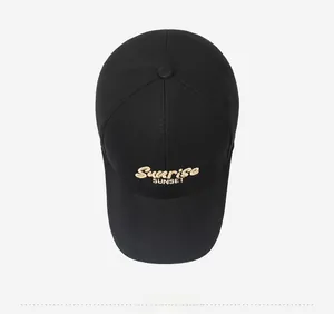 Top view of black canvas baseball cap featuring Sunrise Sunset embroidery on grey background