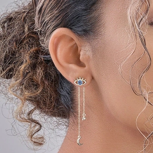 Detailed view of S925 silver evil eye earrings with star and moon chain tassels on a model
