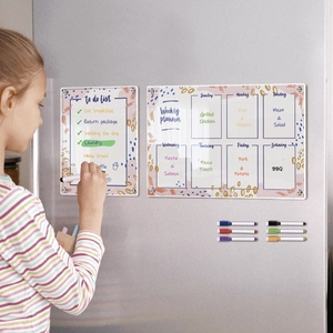 Kitchen scene showing a girl writing on the magnetic acrylic weekly planner and to-do list