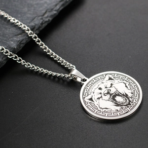 Macro view of silver stainless steel wolf pendant necklace with roar animal engraving