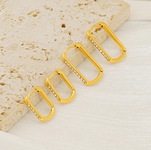 Detailed view showing four sizes of gold-plated rectangular U-shaped zircon earrings