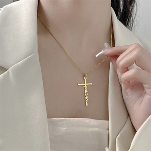 Patience cross pendant necklace in gold titanium steel on model with beige suit