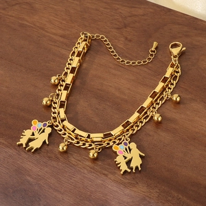 Detail of double-layer gold stainless steel bracelet with mother-daughter and balloon charms