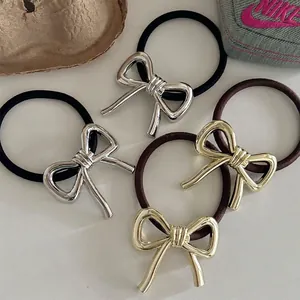 Set of four bow elastic hair ties in gold and silver metal with black and brown bands