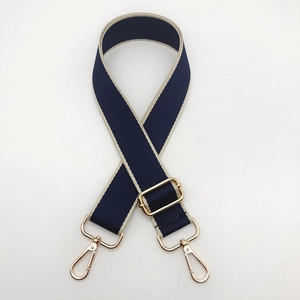 Close-up of 3.8cm navy and cream woven strap with adjustable golden lobster clasps