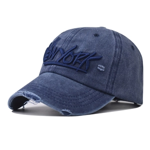 Macro detail of distressed washed cotton baseball cap with New York 3D embroidery