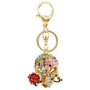 Gothic skull keychain with colorful rhinestones and a red rose flower in mouth