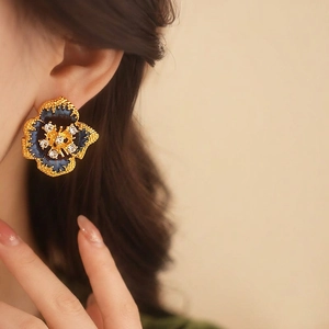 Vintage gold-plated flower earrings with deep blue enamel and sparkling crystals