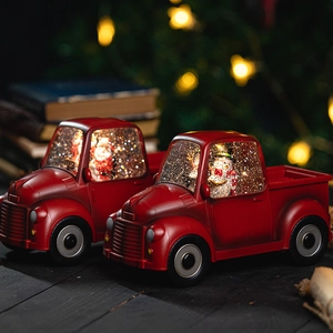 Vintage red Christmas truck snow globe with Santa and Snowman inside, warm glowing lights