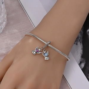 Detailed view of angel pendants with Peace and Hope engraving on silver snake chain bracelet
