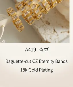 Macro shot of gold baguette-cut zircon hoop earrings on a decorative white branch