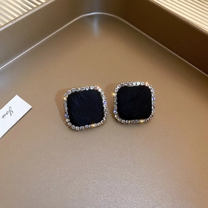 Detail of square vintage earrings with black velvet center and crystal borders