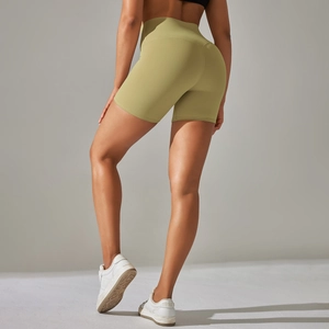 Detail view of high-waist yoga shorts in olive green with a matte brushed fabric finish