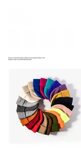 Detailed view of winter knitted beanies in various vibrant colors and warm thick fabric