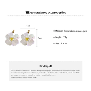 Detailed view of white sequin flower earrings with zircon centers and size markings