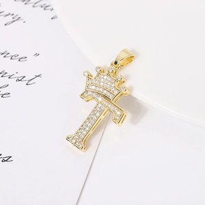 Detail of gold-plated letter F pendant with crown motif and sparkling white zircons
