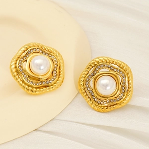 Macro shot of retro gold flower stud earring featuring round pearl and sparkling zircon