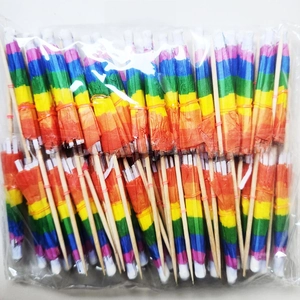 Detailed view of colorful paper rainbow umbrella toothpicks for cocktail and fruit decoration