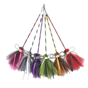 Set of colorful Halloween witch brooms with mesh bristles and sequined ribbons