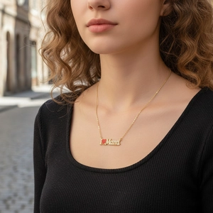 Detail of 18K gold-plated Mama necklace with red heart and white zirconia stones