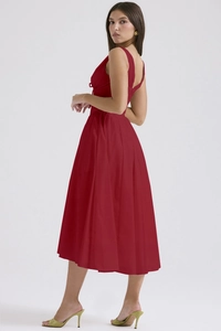 Detail of red V-neck midi dress featuring elegant back cutout and side ribbon tie details