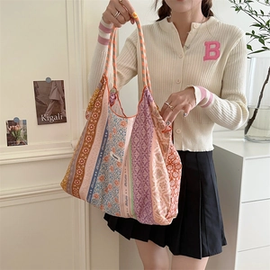 Close-up of floral patchwork tote bag showing colorful patterns and bohemian fabric texture