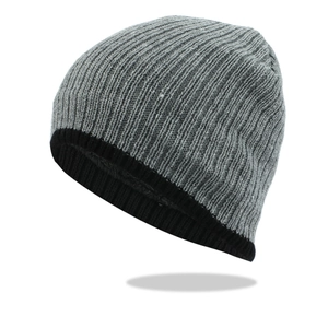 Detail of the gray and black striped knit beanie featuring a ribbed cuff for winter warmth