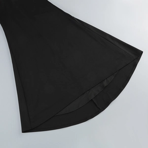 Detail of the elegant fishtail hem and fabric texture of a black off-shoulder evening dress