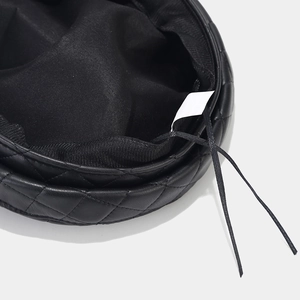 Detail of quilted leather military hat interior with adjustable drawstring and lining