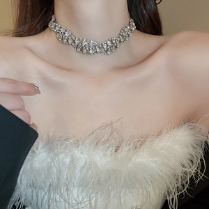 Detail of silver twisted rhinestone choker necklace showing multi-layer crystal design