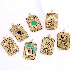 Set of seven gold plated brass tarot card charms with enamel inlay on white background
