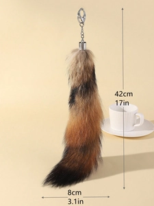 Detail showing oversized faux fur tail keychain measuring 42cm long and 8cm wide