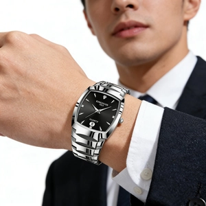 Close-up of KINGNUOS men's silver quartz watch with black dial and calendar on a wrist