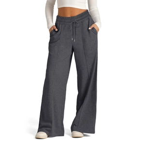 Detail of high-waist drawstring wide-leg pants with center seam and side pockets