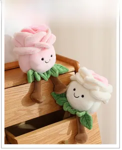 Detail of plush rose flower doll with cute face embroidery and long legs on wood cabinet