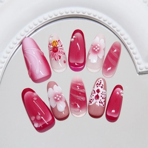 Floral press-on nails with 3D water drops and pink gradient finish on mirror base
