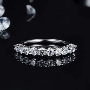 Detailed view of silver eternity ring with round brilliant cut moissanite stones