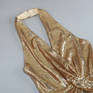 Detail of gold sequin halter top featuring a deep V-neck and elegant knot pleats