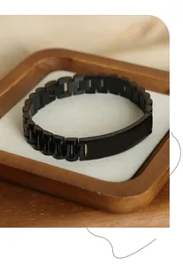 Macro shot of matte black stainless steel watch-style bracelet with customizable metal plate