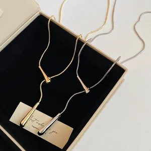 Sleek metallic drop pendant Y-necklace in gold and silver finish with snake chain style